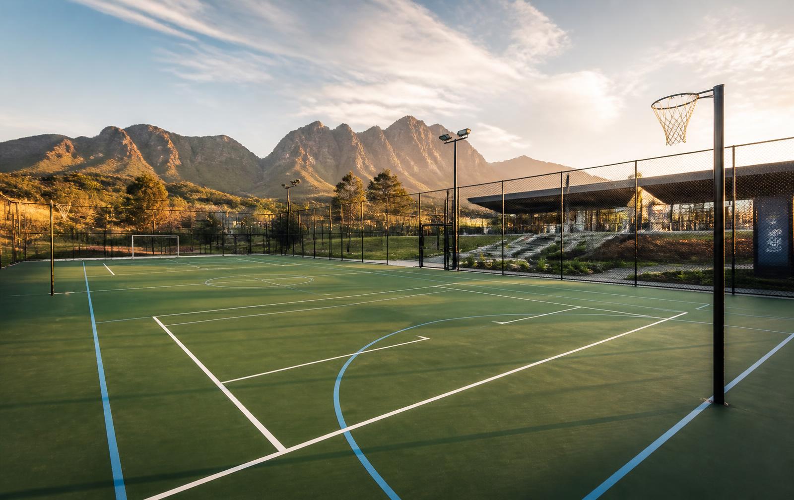 New multi sport court with fencing at golden hour